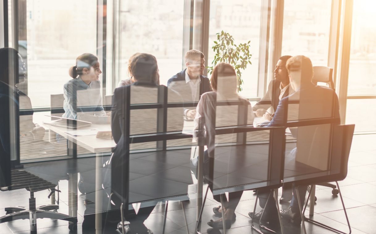 Team in an office meeting sitting at chairs